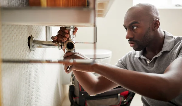 a male plumber fixing a pipe connection from Plumber Pflugerville in Pflugerville, TX Plumber near me a male plumber fixing a pipe connection from Plumber Pflugerville in Pflugerville, TX Plumber near me